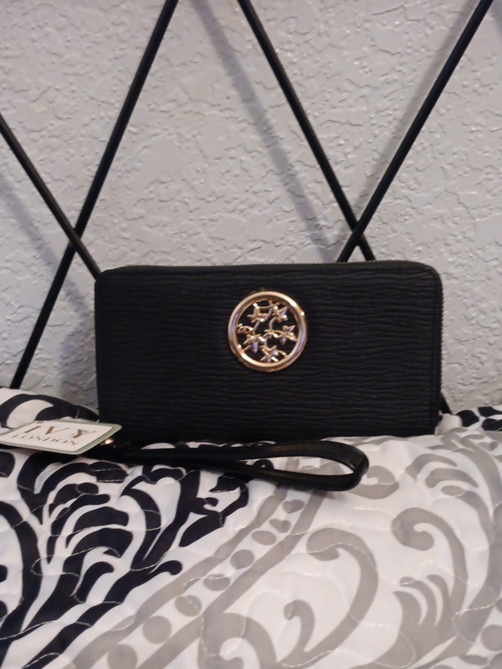 Elegant Black Wristlet Wallet with Gold Emblem